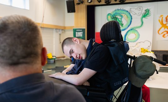 Boy smiling with this support worker.