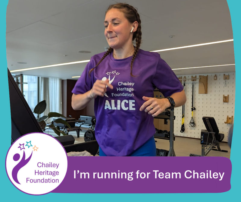 Girl running on a treadmill smiling.