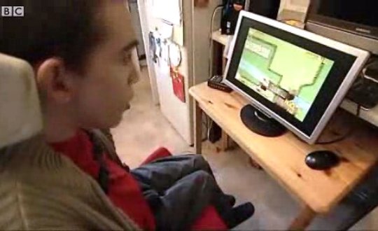 Young man playing Snake on the computer.