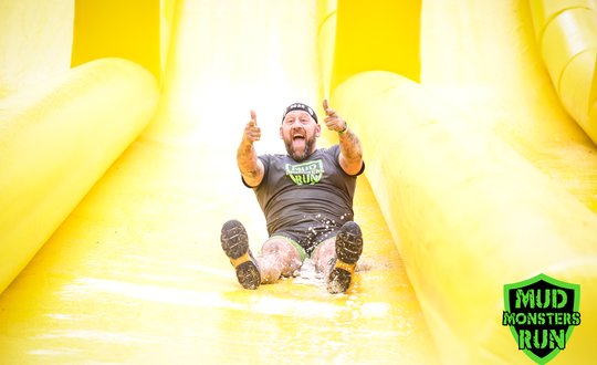 Man sliding down an inflatable slide