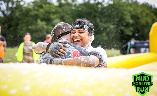 Couple hugging while covered in bubbles