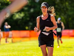 Women dressed in black running outside.