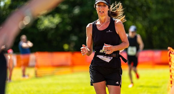 Women dressed in black running outside.