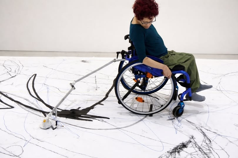 Adaptive drawing equipment attached to a wheelchair.