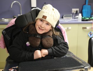 Girl wearing a cream woolly hat.