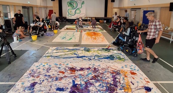 Colourful art sheets on the floor.