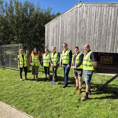 Group of people in hi-vis jackets at construction site