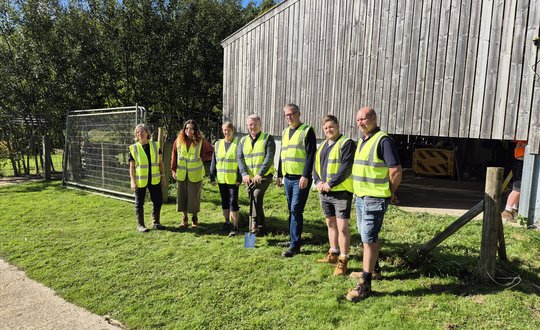 Group of people in hi-vis jackets at construction site
