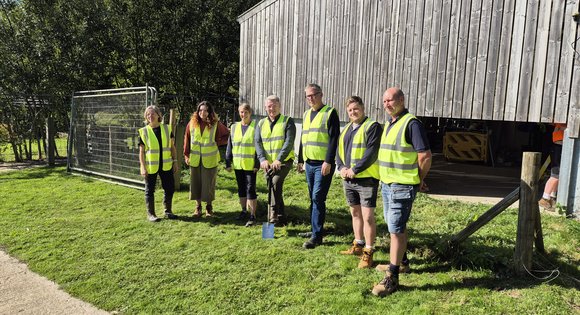 Group of people in hi-vis jackets at construction site