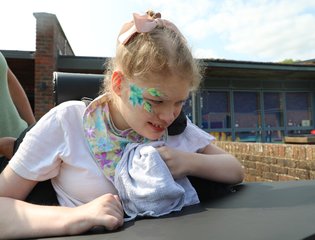 Girl with flower face painting on.
