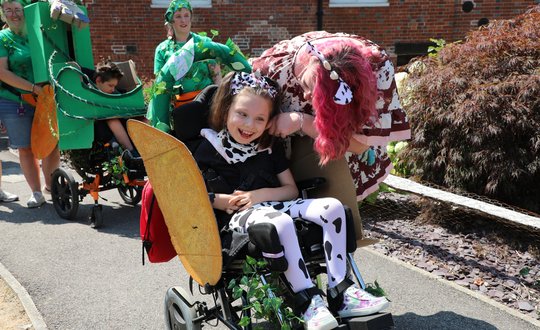 Young girl smiling dressed up as an animal.