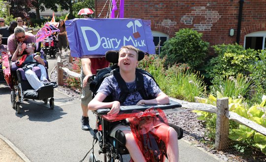 Boy smiling while dressed up as a dairy milk bar.