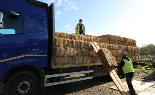A transport van filled with hay