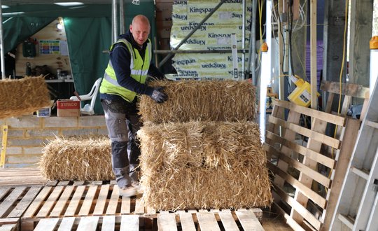 Man sorting Bales into piles