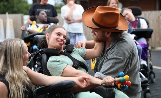 Man and young girl dancing together.