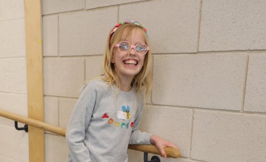 young girl balancing on uni cycle