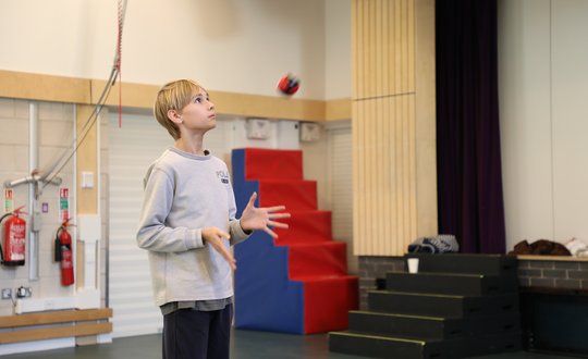 boy catching a juggling ball