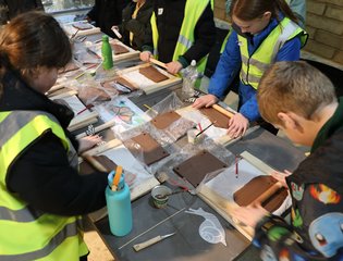 Children at a table sculpting clay.