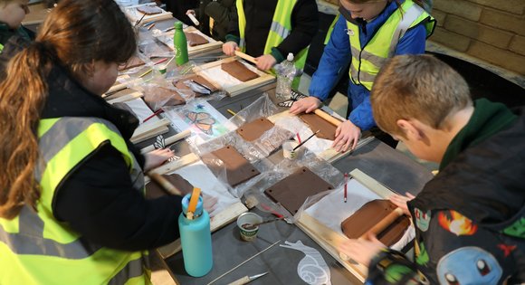 Children at a table sculpting clay.