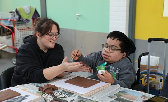 Boy painting clay.