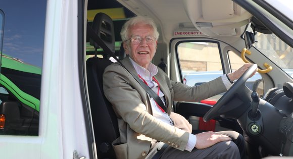 Volunteer driver smiling in van
