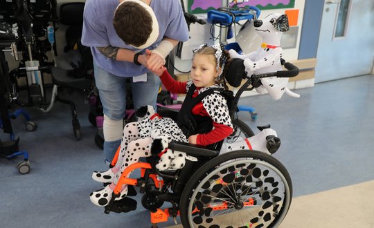 Young girl dressed up as a dalmatian.