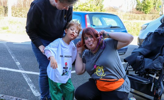 Young boy and Worker pulling silly faces.