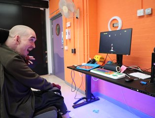 Man in wheelchair playing accessible space invaders