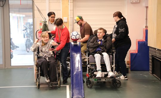 Girl and Boy playing adaptive games together.