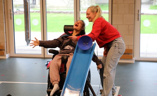 Girl smiling while playing adaptive games.