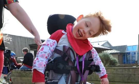 Boy smiling with red clothes.