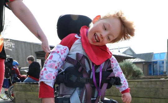 Boy smiling with red clothes.