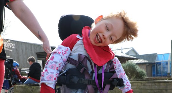 Boy smiling with red clothes.