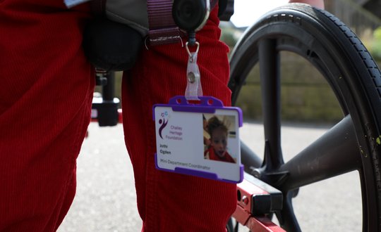 Young boy pretending to be a worker with a badge.