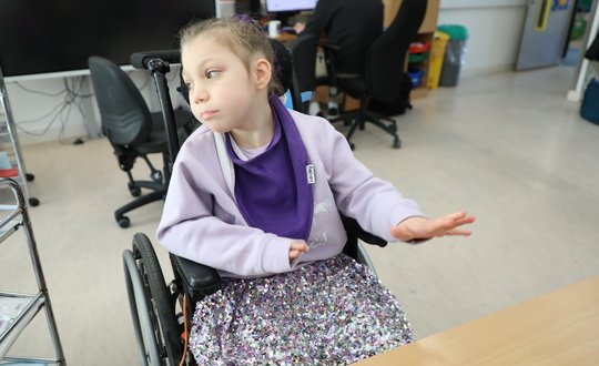 Young girl with a sparkly purple skirt.