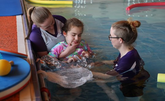 Young girl touching sensory textures.