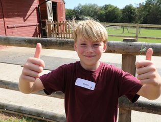Boy giving two thumbs up.