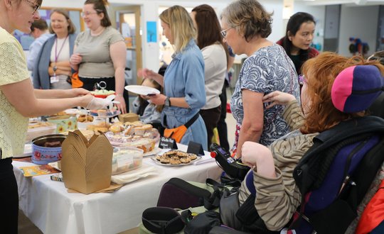 Girl waiting for her cakes at a bake sale.