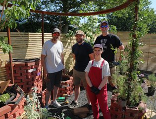 people standing in a garden.