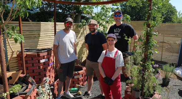people standing in a garden.