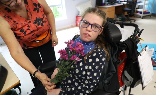 Girl holding her flowers.