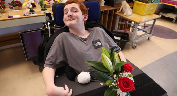 Boy smiling with his flower arrangements.