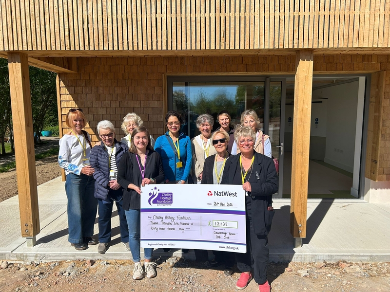 Group of ladies presenting a cheque.