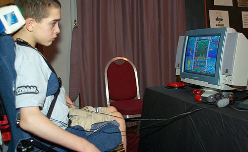 Young man in a wheelchair playing Poku.
