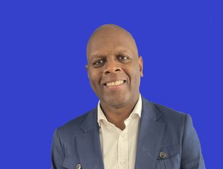 Man smiling against a blue background
