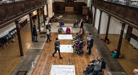 Adaptive drawing equipment attached to a wheelchair.