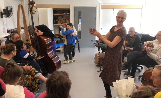 Young boy dancing with support worker.