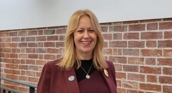 Women smiling with blonde hair.