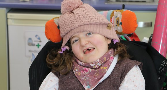 Young girl with a pink woolly hat on.