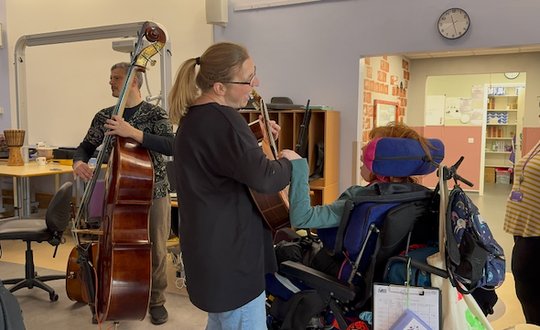 Girl dancing with support worker.
